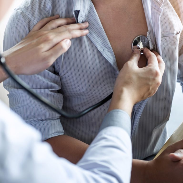 Doctor using a stethoscope to listen to a man's chest during a Cardiovascular Health checkup, offering services like low testosterone treatment, weight management, preventative care, chronic condition management, concierge healthcare, and facial and body scans at Men's Only Medical in West Palm Beach and Palm Beach.